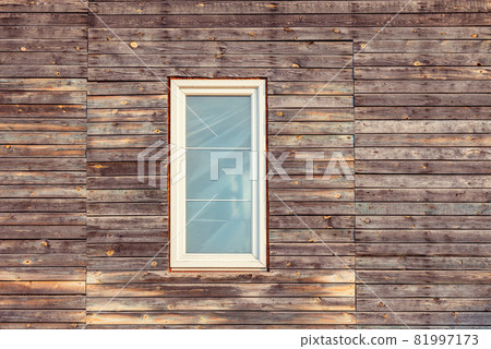 White plastic window in the wooden ancient wall. 81997173