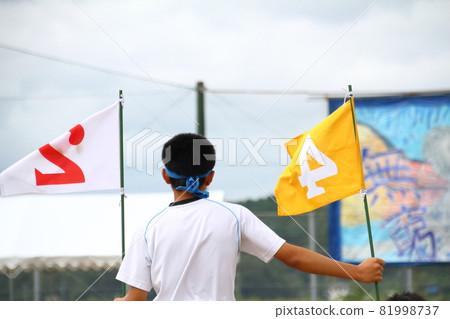 An officer student with a flag of order of arrival at a junior high school athletic festival An officer student with a flag of order of arrival at a junior high school athletic festival 81998737