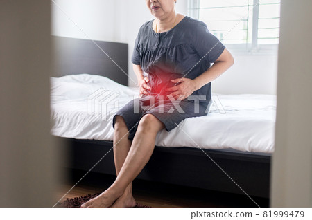 Elderly asian woman having painful  at home,Senior female suffering from abdominal pain 81999479