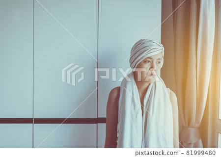 Unhappy asian women with disease cancer is looking something and sitting at house,Female felling depress and upset 81999480