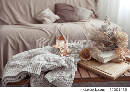 Fall vibe with fall decor details and a knitted sweater in the room. Fall vibe with fall decor details and a knitted sweater in the room. 82001486