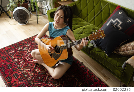 A young woman relaxing in the room A young woman relaxing in the room 82002285