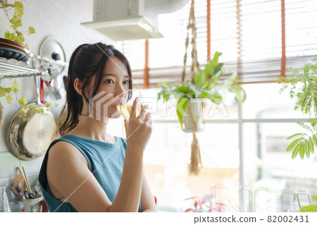 A woman drinking tea in the kitchen A woman drinking tea in the kitchen 82002431