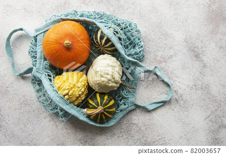 Autumn composition with assorted pumpkins in eco string bag 82003657