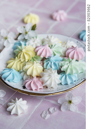 Small colorful meringues in the ceramic  plate 82003662