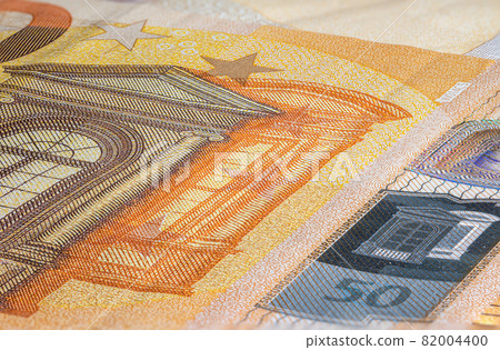 Macro close up on the design surface of 50 euro notes. Banknotes of the European Union. Wallpaper background of money. Detailed currency closeup. Euros isolated flat capture, New Fifty Euro Note Macro close up on the design surface of 50 euro notes. Banknotes of the European Union. Wallpaper background of money. Detailed currency closeup. Euros isolated flat capture, New Fifty Euro Note 82004400