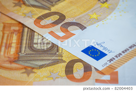 Close up on 50 Euro banknote with the European flag. Euro, currency of European Union. Financial background. Detailed macro capture. Background of fifthy euro bills. Fragment part of 50 euro money Close up on 50 Euro banknote with the European flag. Euro, currency of European Union. Financial background. Detailed macro capture. Background of fifthy euro bills. Fragment part of 50 euro money 82004403
