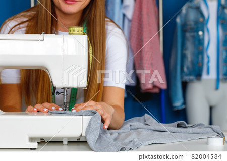 Process of stitching on sewing machine close up view 82004584