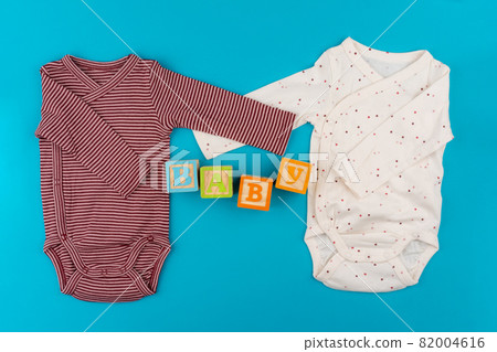 baby clothes on blue background top view 82004616
