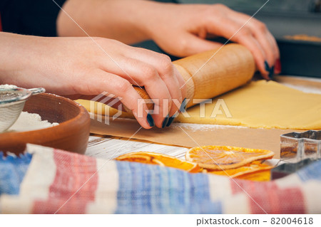 Close up of Woman's hands preparing dough for cookies 82004618