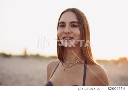 Photo of young attractive woman in bikini on beach 82004654