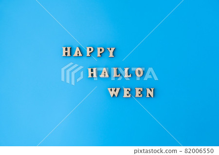 Happy halloween text made of wooden letters on blue background. 82006550