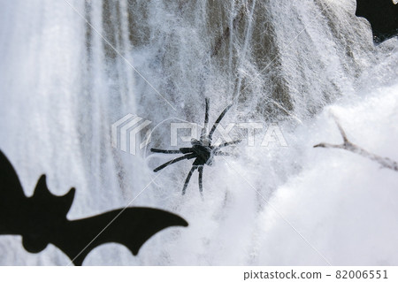 Halloween paper decorations with white spiders on grey background. Black bats and spiders. Copy space 82006551