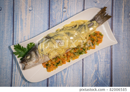 Fish recipe, Baked sea bass with small vegetables and onion sauce, curry, sour cream Fish recipe, Baked sea bass with small vegetables and onion sauce, curry, sour cream 82006585