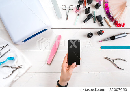 Manicure set and nail polish on wooden background Manicure set and nail polish on wooden background 82007060