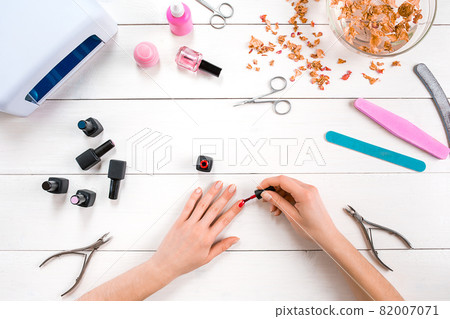 Paint your own nails. Manicure set and nail polish on wooden background 82007071