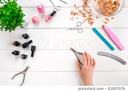 Woman Hands Care. Top View Of Beautiful Smooth Woman's Hands With Professional Nail Care Tools For Manicure On White Background. Woman Hands Care. Top View Of Beautiful Smooth Woman's Hands With Professional Nail Care Tools For Manicure On White Background. 82007076