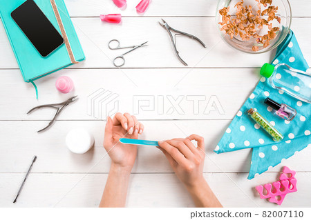 Woman Hands Care. Top View Of Beautiful Smooth Woman's Hands With Professional Nail Care Tools For Manicure On White Background. Woman Hands Care. Top View Of Beautiful Smooth Woman's Hands With Professional Nail Care Tools For Manicure On White Background. 82007110