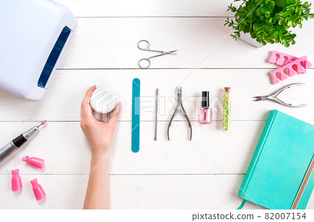 Woman Hands Care. Top View Of Beautiful Smooth Woman's Hands With Professional Nail Care Tools For Manicure On White Background. 82007154