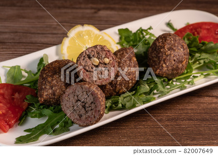 Traditional kebbe and pita bread on big round plate in lebanese restaurant Traditional kebbe and pita bread on big round plate in lebanese restaurant 82007649