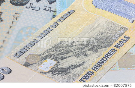 Close up to 200 Rial or Riyal of the Republic Jemen. Paper banknotes of the Arabic country. Detailed capture of the front art design. Detailed money background wallpaper. Currency bank note Yemen Close up to 200 Rial or Riyal of the Republic Jemen. Paper banknotes of the Arabic country. Detailed capture of the front art design. Detailed money background wallpaper. Currency bank note Yemen 82007875