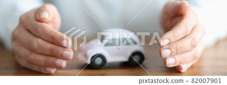 There is white car inside woman hands There is white car inside woman hands 82007901