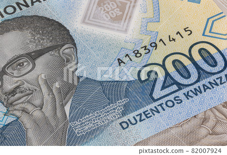 Close up to 500 Kwanza of the Republic of Angola. Polymer banknotes of the African country. Detailed capture of the portrait of the first president Agostinoh Neto. Currency bank note Kwanzas Close up to 500 Kwanza of the Republic of Angola. Polymer banknotes of the African country. Detailed capture of the portrait of the first president Agostinoh Neto. Currency bank note Kwanzas 82007924