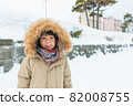 Cute asian boy in snow 82008755