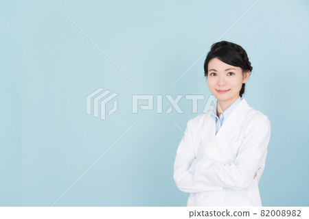 A woman in a lab coat with her arms crossed A woman in a lab coat with her arms crossed 82008982