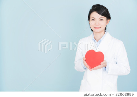A woman in a lab coat with a heart A woman in a lab coat with a heart 82008999