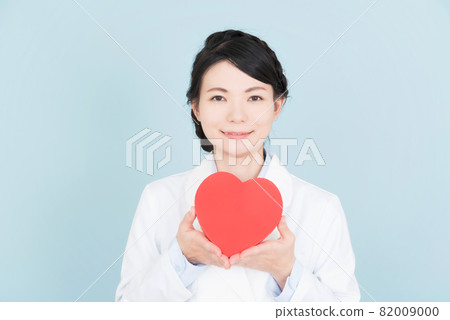 A woman in a lab coat with a heart A woman in a lab coat with a heart 82009000