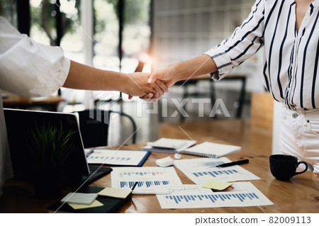 Business woman handshake for the new agreement after sign in agreement contract with work together. Business woman handshake for the new agreement after sign in agreement contract with work together. 82009113