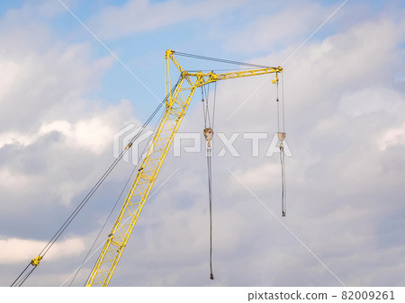 Machine industrial construction crane against the sky with clouds Machine industrial construction crane against the sky with clouds 82009261