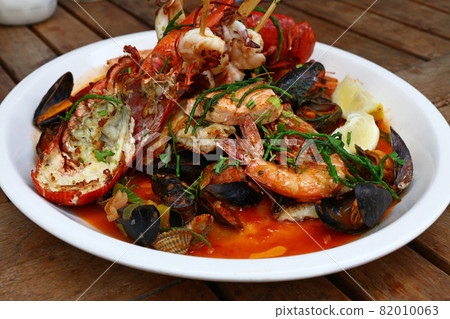 Grilled seafood platter on wooden table Grilled seafood platter on wooden table 82010063