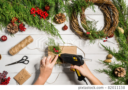 Christmas gift decoration with handmade DIY on a white wooden background. Do it by yourself. Christmas gift decoration with handmade DIY on a white wooden background. Do it by yourself. 82011138
