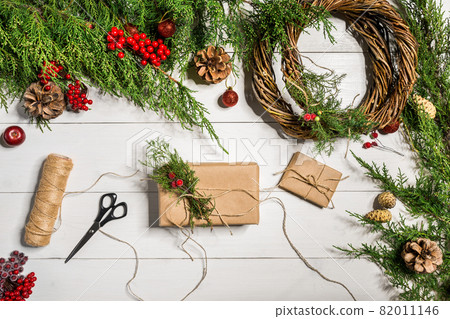 Christmas gift decoration with handmade DIY on a white wooden background. Do it by yourself. 82011146