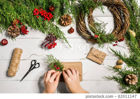 Christmas gift decoration with handmade DIY on a white wooden background. Do it by yourself. Christmas gift decoration with handmade DIY on a white wooden background. Do it by yourself. 82011147