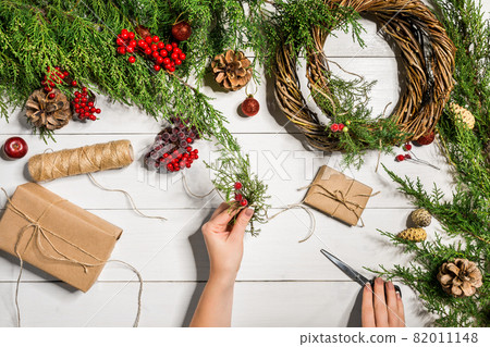 Christmas gift decoration with handmade DIY on a white wooden background. Do it by yourself. Christmas gift decoration with handmade DIY on a white wooden background. Do it by yourself. 82011148