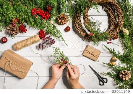 Christmas gift decoration with handmade DIY on a white wooden background. Do it by yourself. Christmas gift decoration with handmade DIY on a white wooden background. Do it by yourself. 82011149