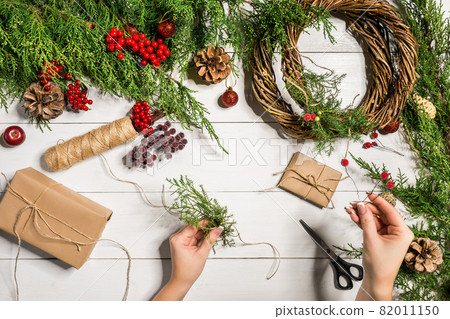 Christmas gift decoration with handmade DIY on a white wooden background. Do it by yourself. Christmas gift decoration with handmade DIY on a white wooden background. Do it by yourself. 82011150
