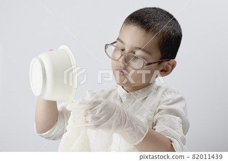 Overhead view of a a little kid experimenting with liquids at home Overhead view of a a little kid experimenting with liquids at home 82011439