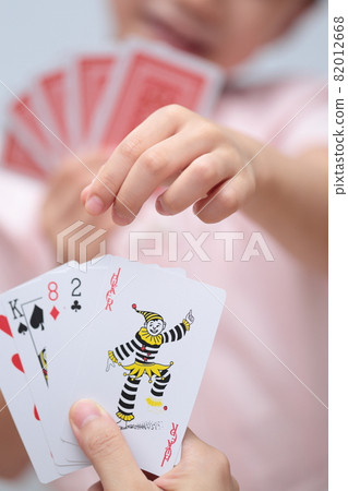 Girl playing cards to maid 82012668