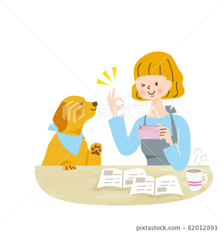 Young woman playing with a dog with a smartphone 82012893