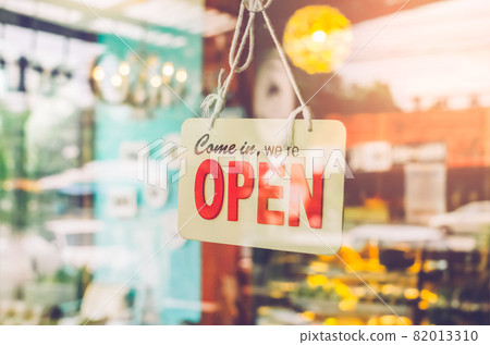 Open sign hanging front of cafe with colorful bokeh light abstract background. Open sign hanging front of cafe with colorful bokeh light abstract background. 82013310