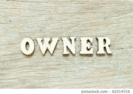 Alphabet letter in word owner on wood background Alphabet letter in word owner on wood background 82014558