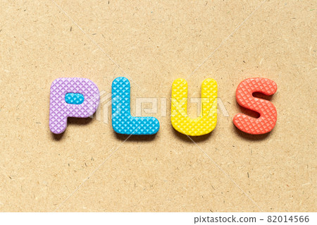 Foam alphabet letter in word plus on wood background Foam alphabet letter in word plus on wood background 82014566