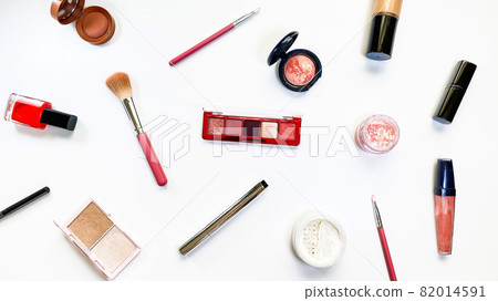 Beauty concept. Makeup products shadows, highlighter, blush, brushes, powder, glitter, mascara, gloss, lipstick, pencil on white background Beauty concept. Makeup products shadows, highlighter, blush, brushes, powder, glitter, mascara, gloss, lipstick, pencil on white background 82014591