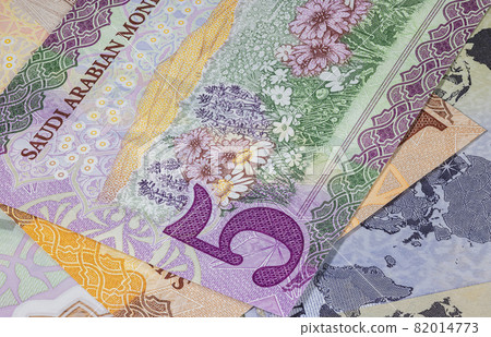Close up photography of Saudi Arabian money. Paper Currency of Saudi Arabia. Saudi Riyal with the portrait of King Salman. Monetary Authority unveiled new family of banknotes. Detailed design capture Close up photography of Saudi Arabian money. Paper Currency of Saudi Arabia. Saudi Riyal with the portrait of King Salman. Monetary Authority unveiled new family of banknotes. Detailed design capture 82014773
