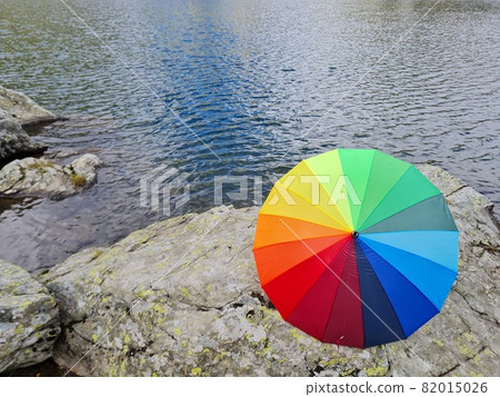 colorful ambarella against a lake of water room for text colorful ambarella against a lake of water room for text 82015026