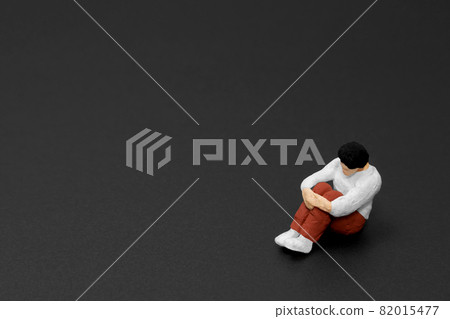 A man holding his knees A man holding his knees 82015477